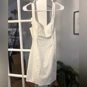 Light white dress. Slightly cinched around natural waist. Open area in back